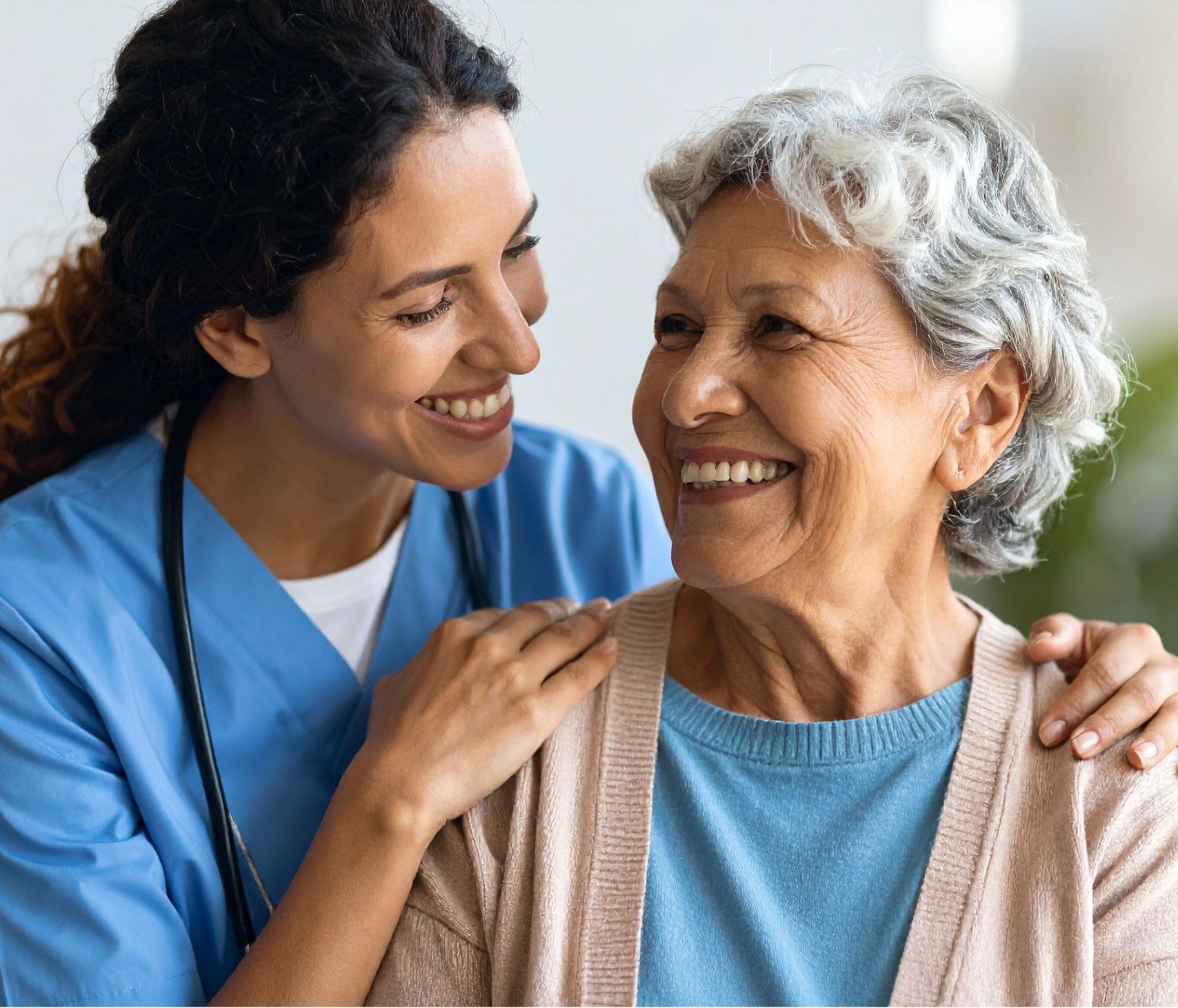 Core Health Group caregiver sharing a warm moment with an elderly patient